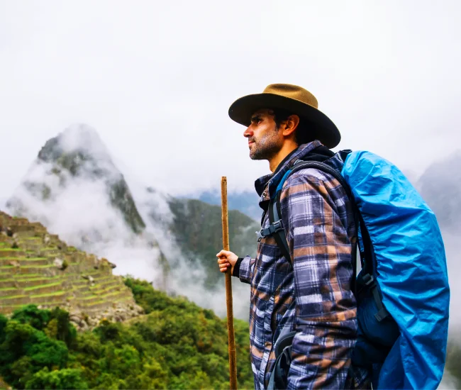 Hiker on the Inca Trail to Machu Picchu in Peru | Conde Travel Adventures Solo hiker trekking the Inca Trail towards Machu Picchu, surrounded by the Andes Mountains of Peru | Conde Travel Adventures