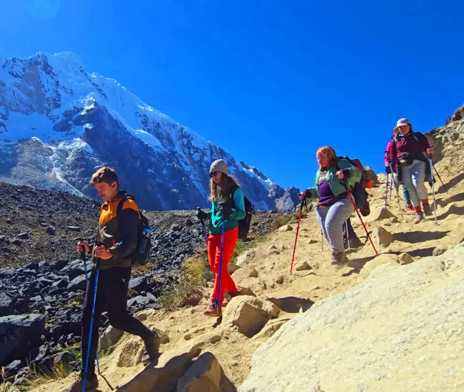Hikers Descending Abra Salkantay Peru | Conde Travel Adventures Hikers descending Abra Salkantay on the trek to Machu Picchu in the Peruvian Andes | Conde Travel Adventures