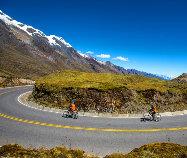 Inca Jungle Biking on Abra Málaga Road in Peru | Conde Travel Adventures Cyclist riding along the scenic Abra Málaga road during the Inca Jungle tour to Machu Picchu | Conde Travel Adventures